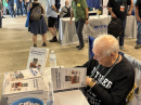 ARRL author Glen Popiel, KW5GP, signing books at the “Meet the Author” area of ARRL Expo. [Rich Moseson, W2VU, photo]